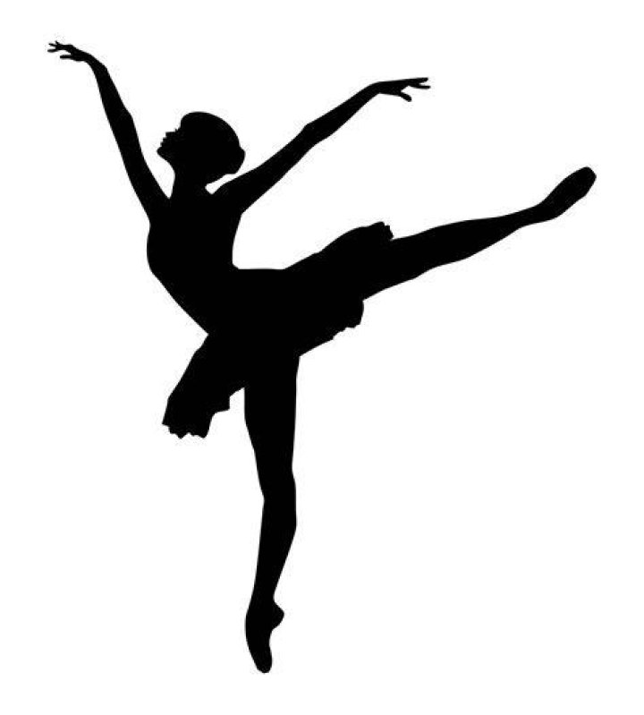 a dancer in a black and white costume set against an orange backdrop a dancer in a black and white costume set against an orange backdrop
