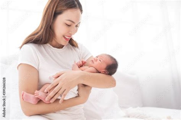 a woman holding a baby a woman holding a baby