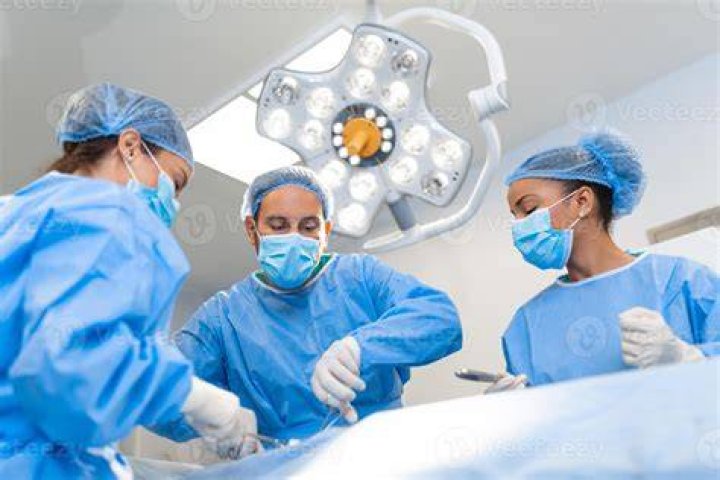 Medical team of surgeons in hospital doing caesarean medical team of surgeons in hospital doing caesarean